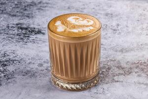 A coffee with a rose pattern in the middle photo