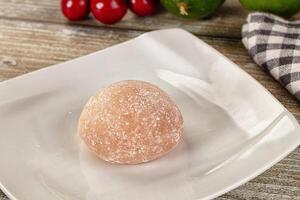 A white plate with a ball of dough on it photo