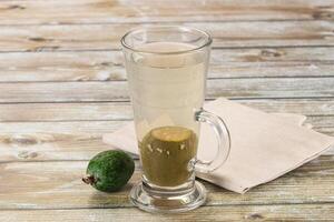 A glass of water with a lime and a green apple photo
