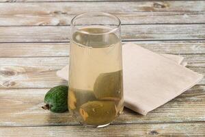 A glass of water and a lemon on a table photo
