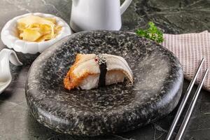 A plate with a sushi roll on it and chopsticks photo