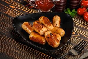 A black plate with some sausages on it photo