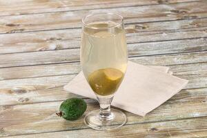 A glass of white wine with an avocado on a napkin photo