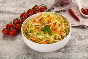 A bowl of coleslaw with tomatoes and other vegetables photo
