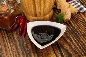 A bowl of sauce with spices and ginger photo