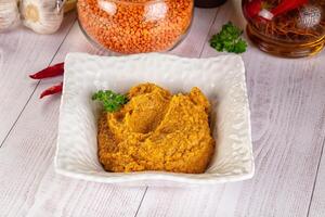 A bowl of hummus with spices and herbs photo