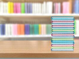 A pile of books on a table in a library. photo