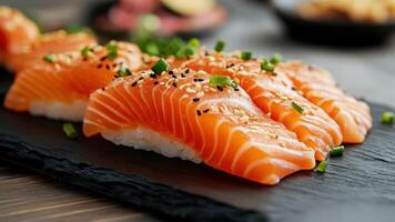 Close Up of Salmon Sushi Nigiri Garnished With Sesame Seeds and Green Onions photo