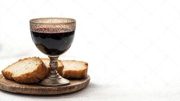 Still Life With Wine In a Chalice and Slices of Bread on a Wooden Plate photo