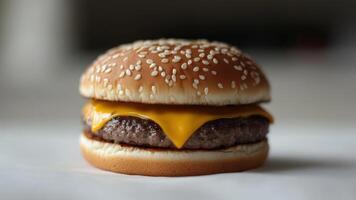 a Cheeseburger With a Beef Patty and Cheese on a Sesame Seed Bun photo