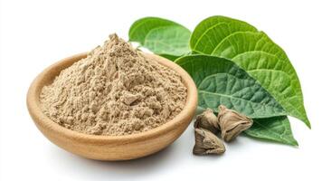 Kava Powder In a Wooden Bowl With Leaves and Kava Root on a White Background photo