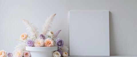 Pastel floral display podium with blank canvas. photo