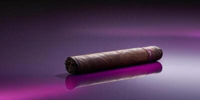 A single cigar sits on a smooth purple reflecting surface. photo