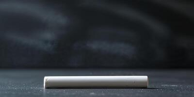 A white cigarette sitting on a table photo
