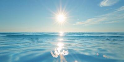 The sun shining over the ocean with waves photo