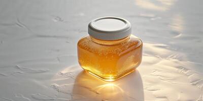 A jar of honey sitting on a table photo