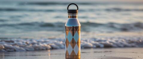 A water bottle sitting on the beach with the ocean in the background photo