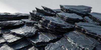 Closeup of layered black rocks with sharp rugged textures and natural shadows photo