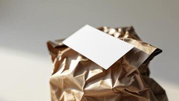 A brown paper bag with a blank card inside photo