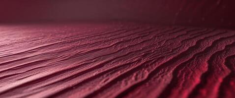 Textured crimson surface with subtle gradient light creating depth and visual interest for backgrounds and designs photo