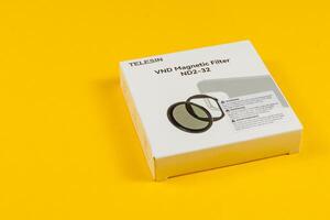 Lviv Ukraine 05.04.25 Magnetic filter packaging on bright yellow background photo
