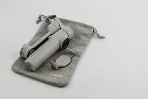 Lviv Ukraine 08.04.25 Handheld stabilizer with pouch on light background photo