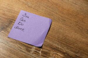 Encouraging note on a wooden table inspires motivation and reflection photo