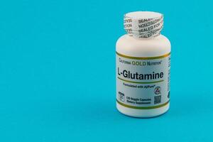 Lviv Ukraine 10.04.25 L Glutamine dietary supplement in a bright blue setting photo