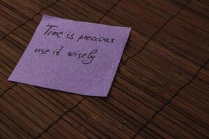 Note on a wooden surface conveying a thoughtful message about time management photo