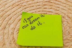 Inspiration note on bright sticky pad placed on woven surface in cozy setting photo