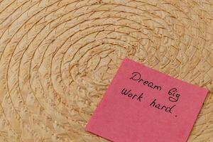 Inspiring message on colorful sticky note beside woven basket photo