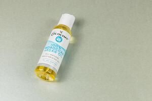 Lviv Ukraine 10.04.25 Natural moisturizer in a clear bottle on silver surface photo