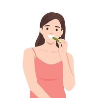 Woman in a coral dress enjoys a fresh cucumber slice, embodying a healthy and refreshing. vector