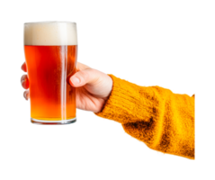 Caucasian female hand holding a glass of amber beer with foam png