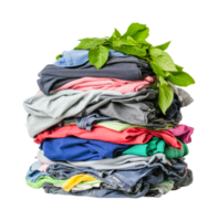 Stack of colorful clothes with fresh green leaves on top png