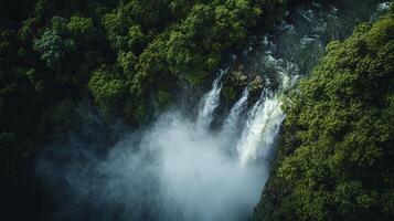 Majestic waterfall cascading through lush green forest photo