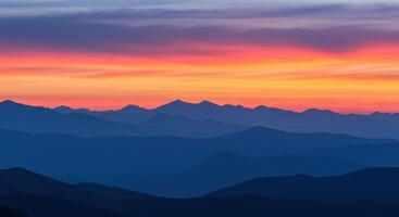 Fiery Sunset Over Mountain Peaks photo