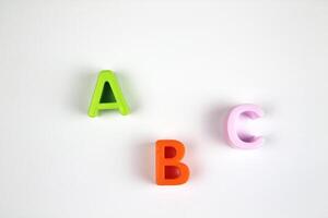 On a white background, bright and colorful letters of the English alphabet in a chaotic order. concept of teaching preschool children photo