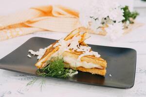 A close-up of delectable grilled sandwich decorated with shredded cheese and fresh herbs, set against a decorative background, emphasizing a pleasant and inviting culinary presentation. photo