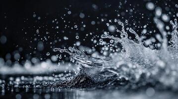 Dynamic black and white macro shot of water splashing against a dark background photo