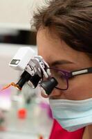 Focused examination in a modern laboratory setting showcasing advanced magnification tools, highlighting precision work during daylight hours photo