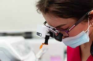 Skilled professional engaged in detailed examination in a sterile environment, showcasing dedication and focus in precision work with advanced tools photo