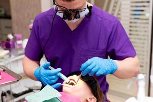 Skillful dentist performing a dental procedure on a training mannequin in a modern clinic with bright lighting photo