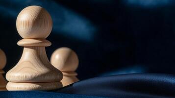 Wooden chess pieces on a blue cloth photo