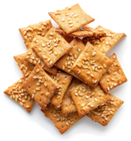 A pile of sesame seed crackers on a white surface. png