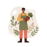 Smiling gardener holding freshly harvested beetroot with green leaves in apron and boots with natural background of leaves and plants vector
