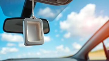 A car dashboard with a phone holder hanging from it photo