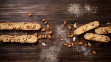 Top view of biscotti and almonds on rustic wooden board photo