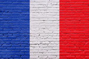 Old brick wall with the flags of France and Italy in a grunge and textured style photo