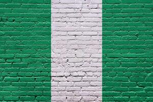 nigeria Grunge Italy flag on a weathered brick wall with textured surface photo